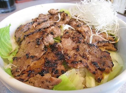 一碗鋪滿烤鮪魚臉頰肉的丼飯。